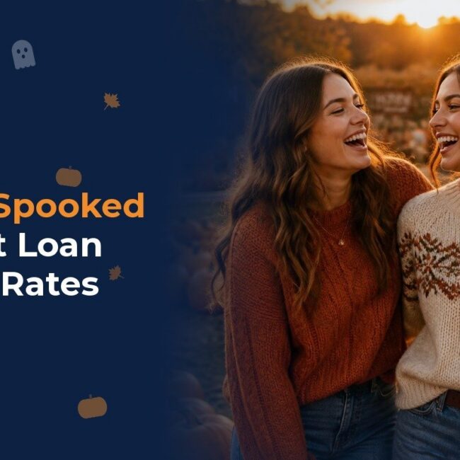 Two friends laughing at a pumpkin patch at sunset one holding a pumpkin carefree after learning the truth about student loan refinance rates